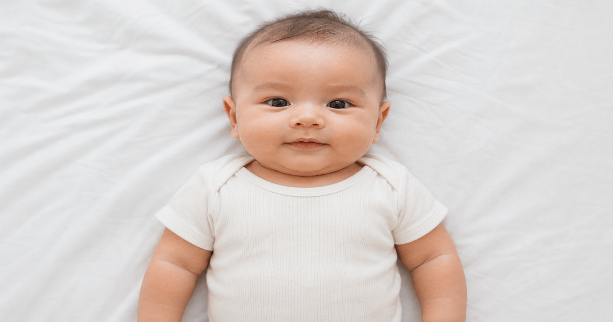 Infant passport picture taken at home on a white sheet for DS-11 applications