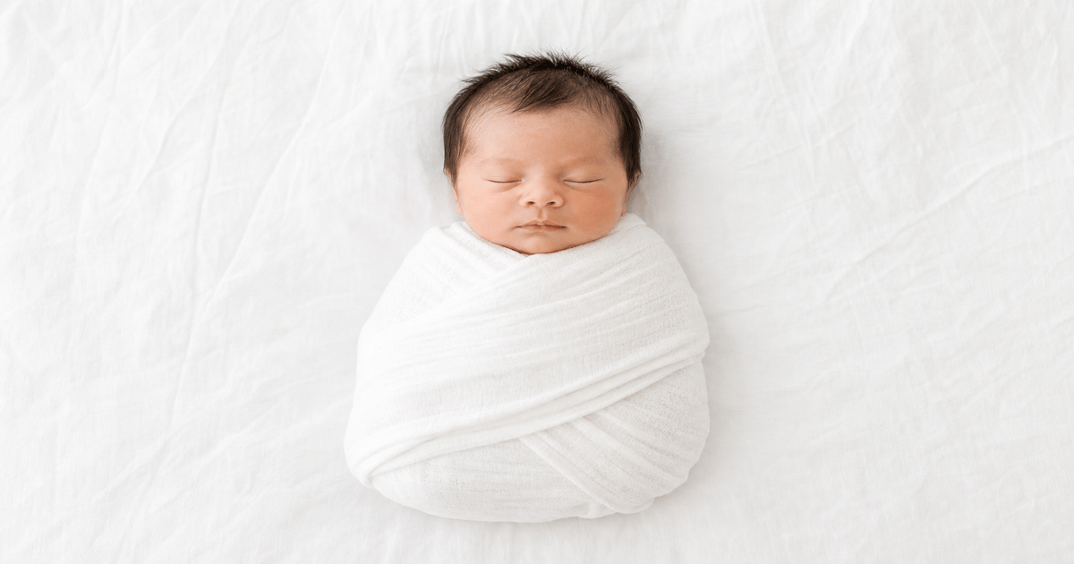 Newborn flat-lay passport picture setup with plain white background